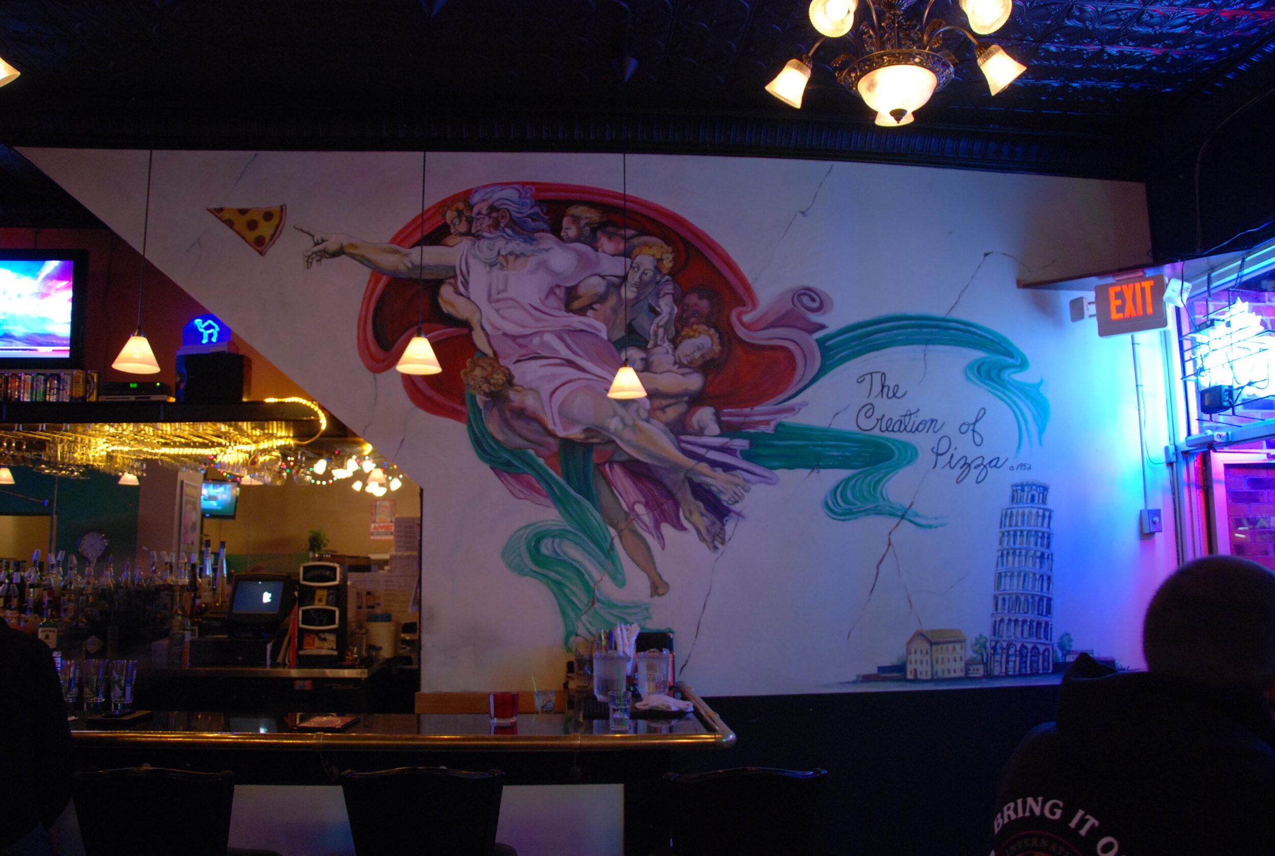 a mural of god reaching for a slice of pizza inside the Leaning Tower